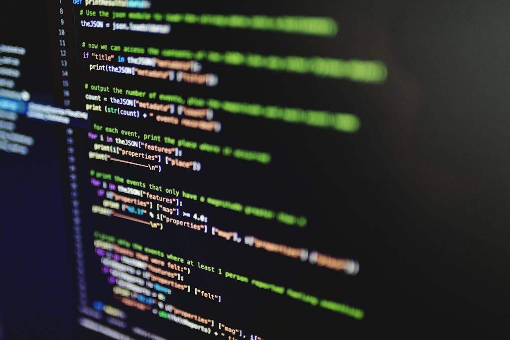 High-resolution image of colorful programming code highlighted on a computer screen.